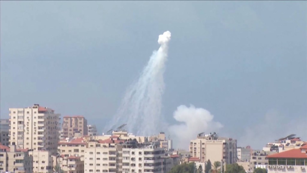 A white cloud of smoke from a phosphorus bomb can be seen over high rise buildings in Gaza.