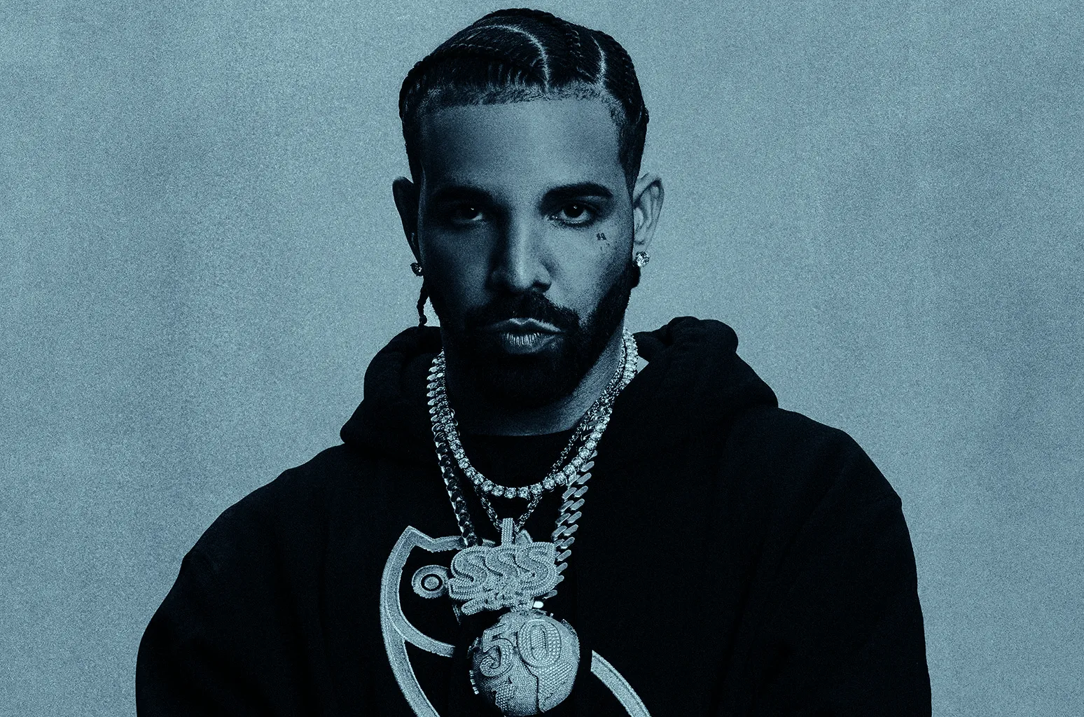 Drake in a promotional photograph wearing a black hooded sweater.
