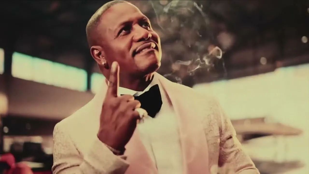 Rapper AZ pictured wearing a suit and bow tie in a promotional still for the release of his new album, Doe or Die III.