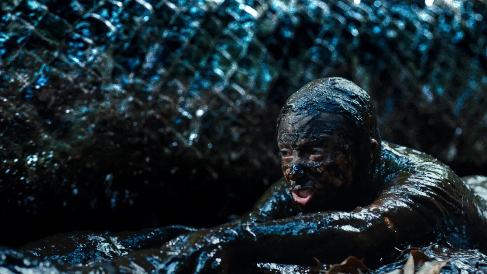 Kiana Madeira crawling through a muddy swamp in Mike P. Nelson’s horror film Beware Boiúna.