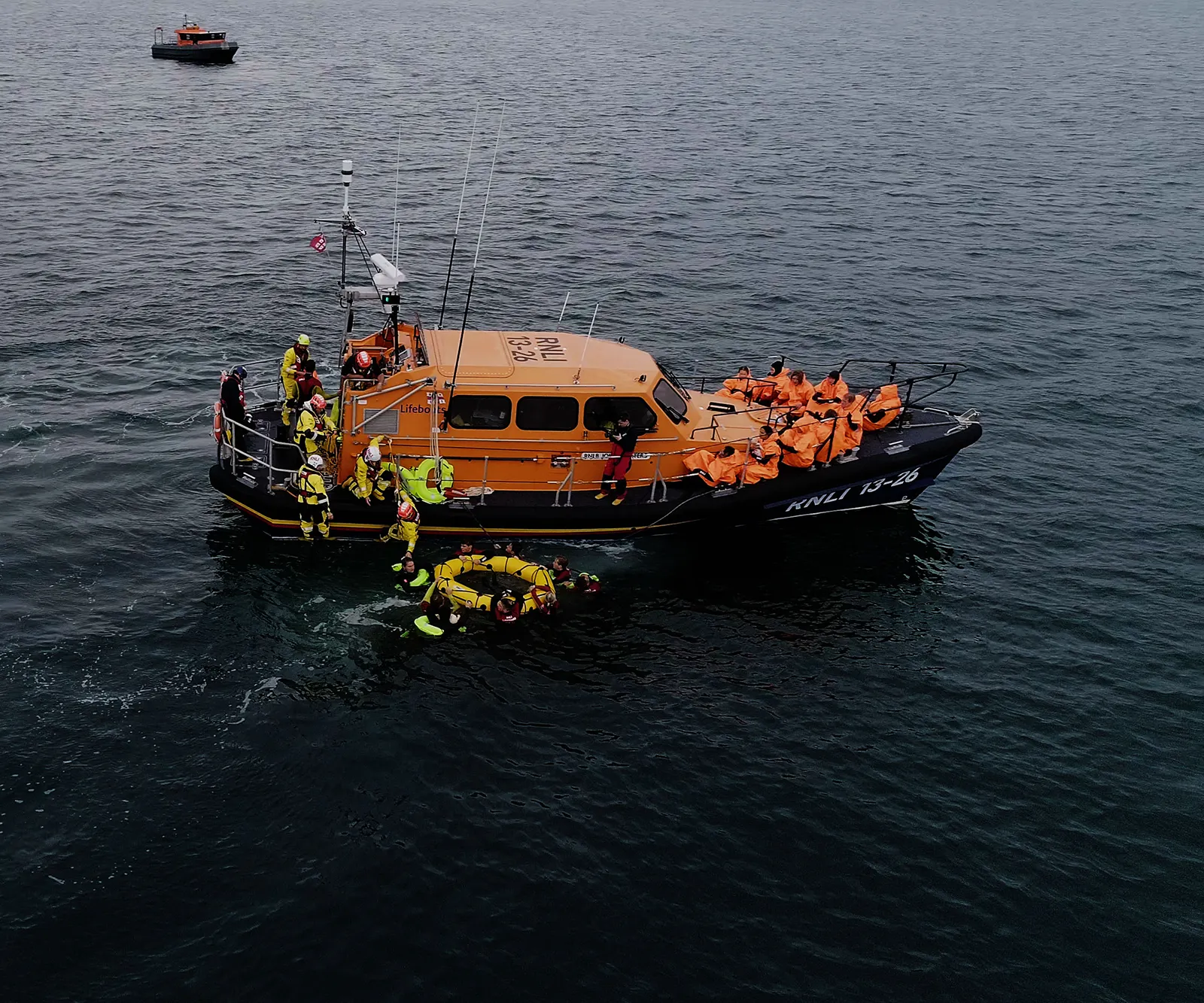 RNLI crews assist people during a small-boat rescue in the English Channel.