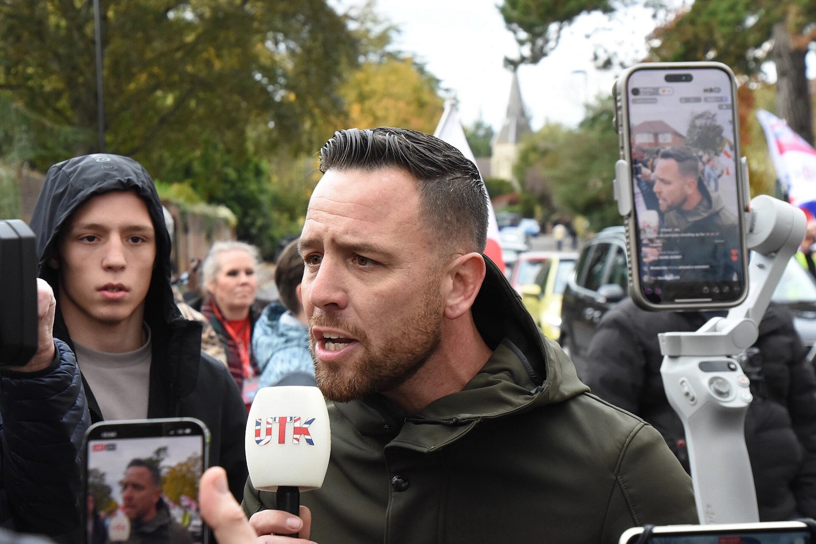 Danny Tommo speaks into a microphone while being filmed at the Southampton Patriots anti-immigration protest in Highfield, Southampton.