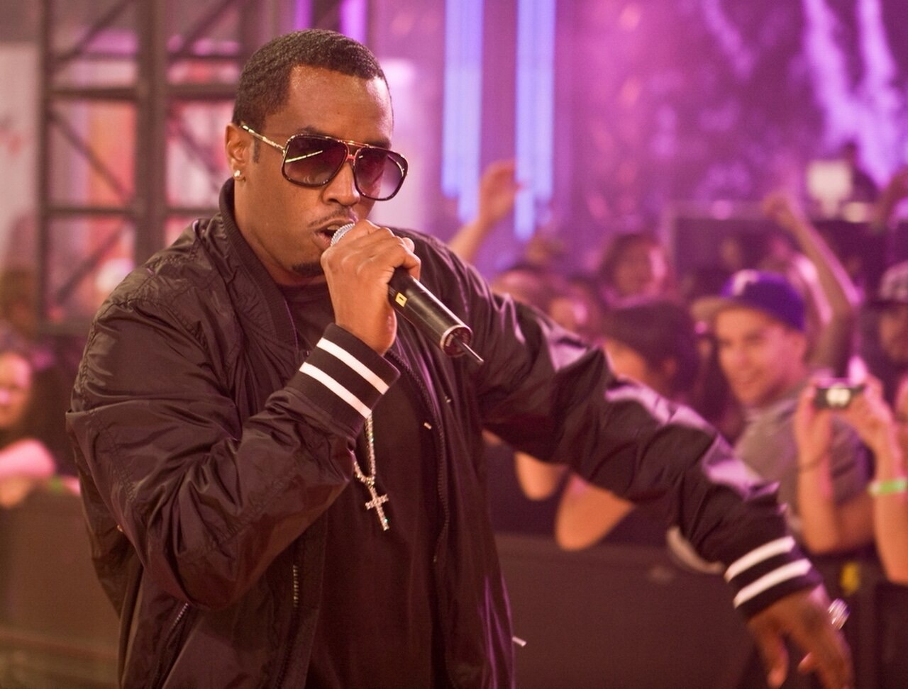 Sean ‘Diddy’ Combs performs onstage wearing sunglasses and a black jacket while holding a microphone at the eTalk Festival Party during the Toronto International Film Festival.