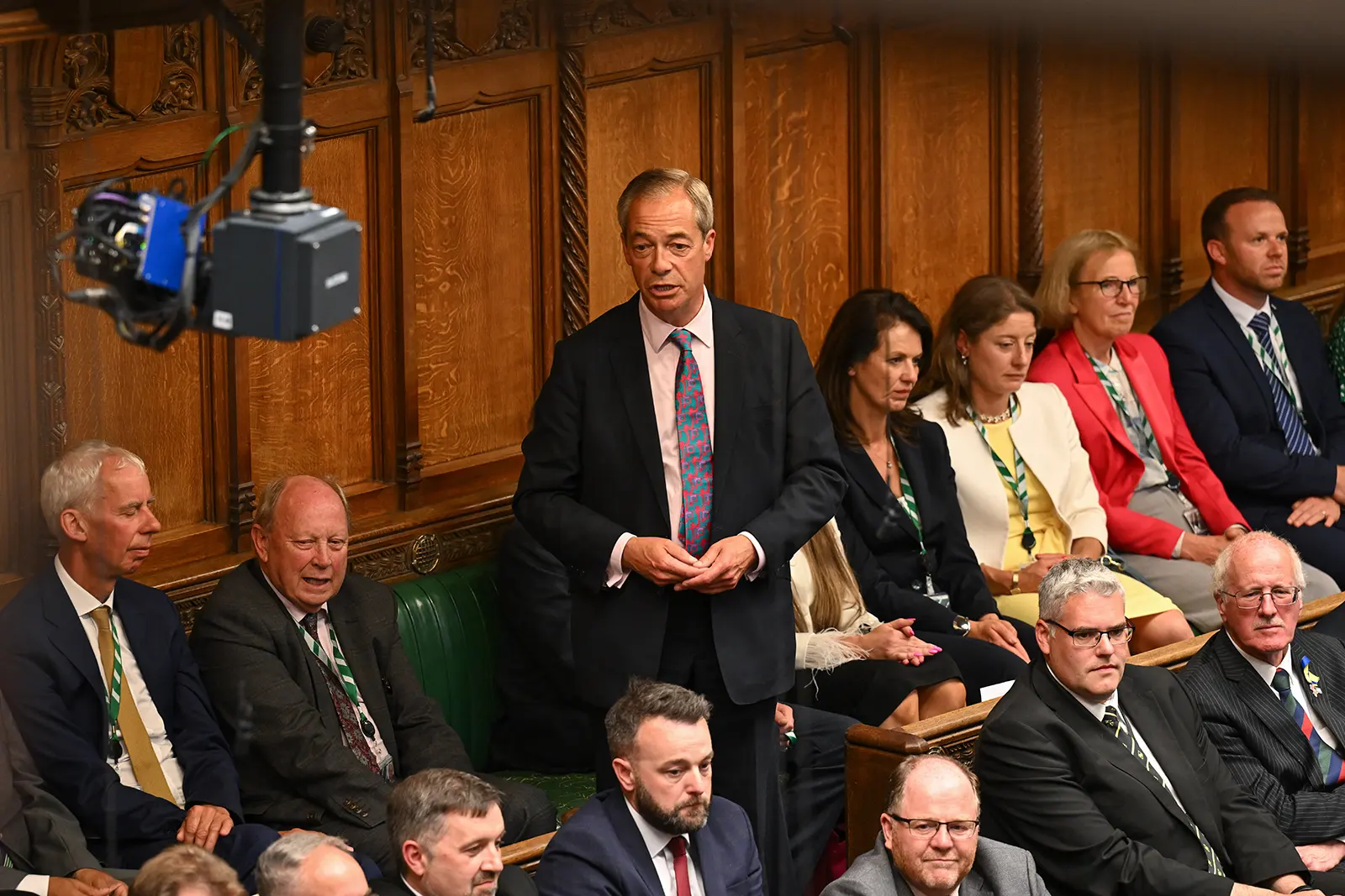 Nigel Farage stands to address MPs in the House of Commons, surrounded by fellow Reform UK members.